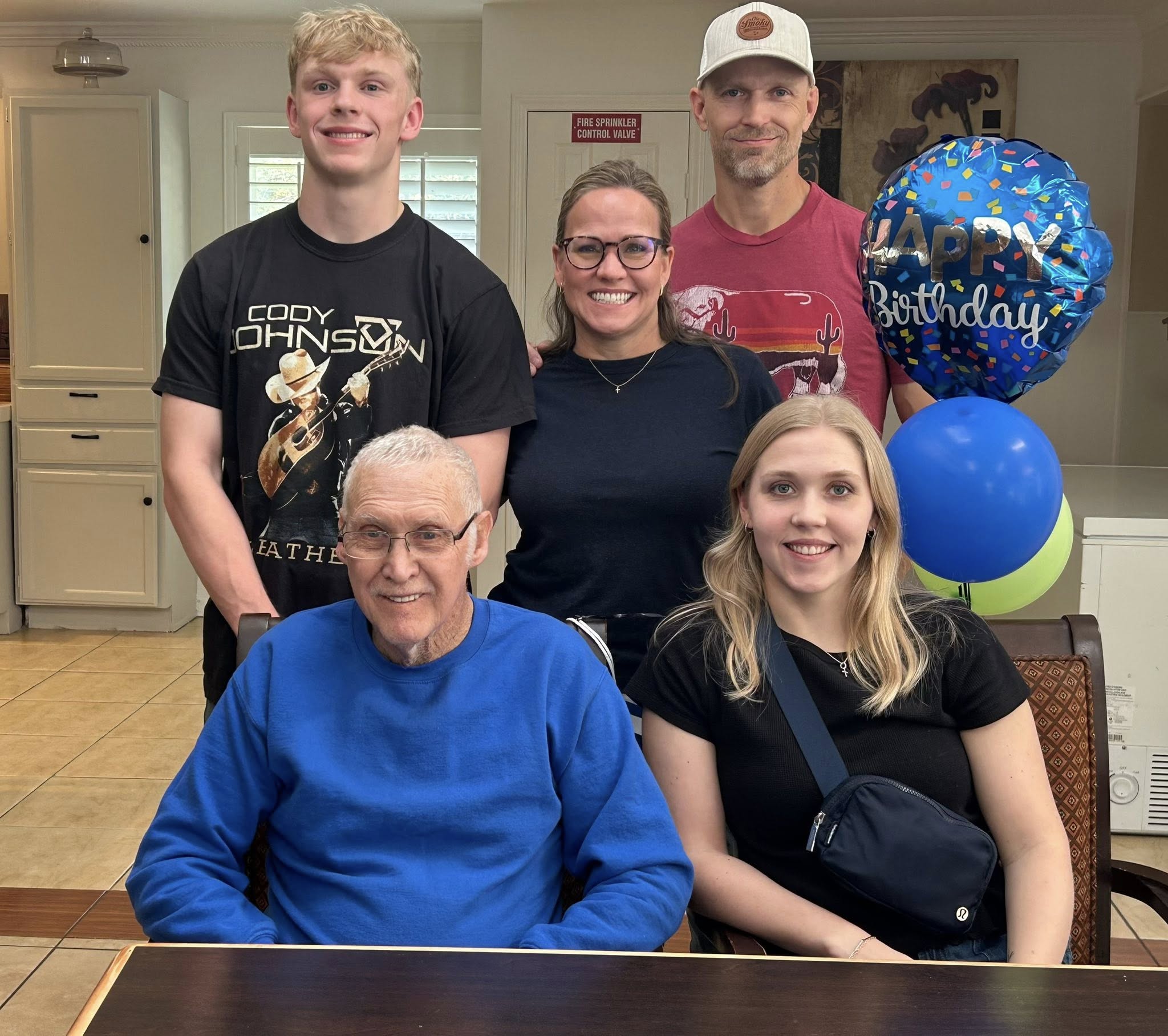 A resident enjoying a birthday celebration with family and cake
