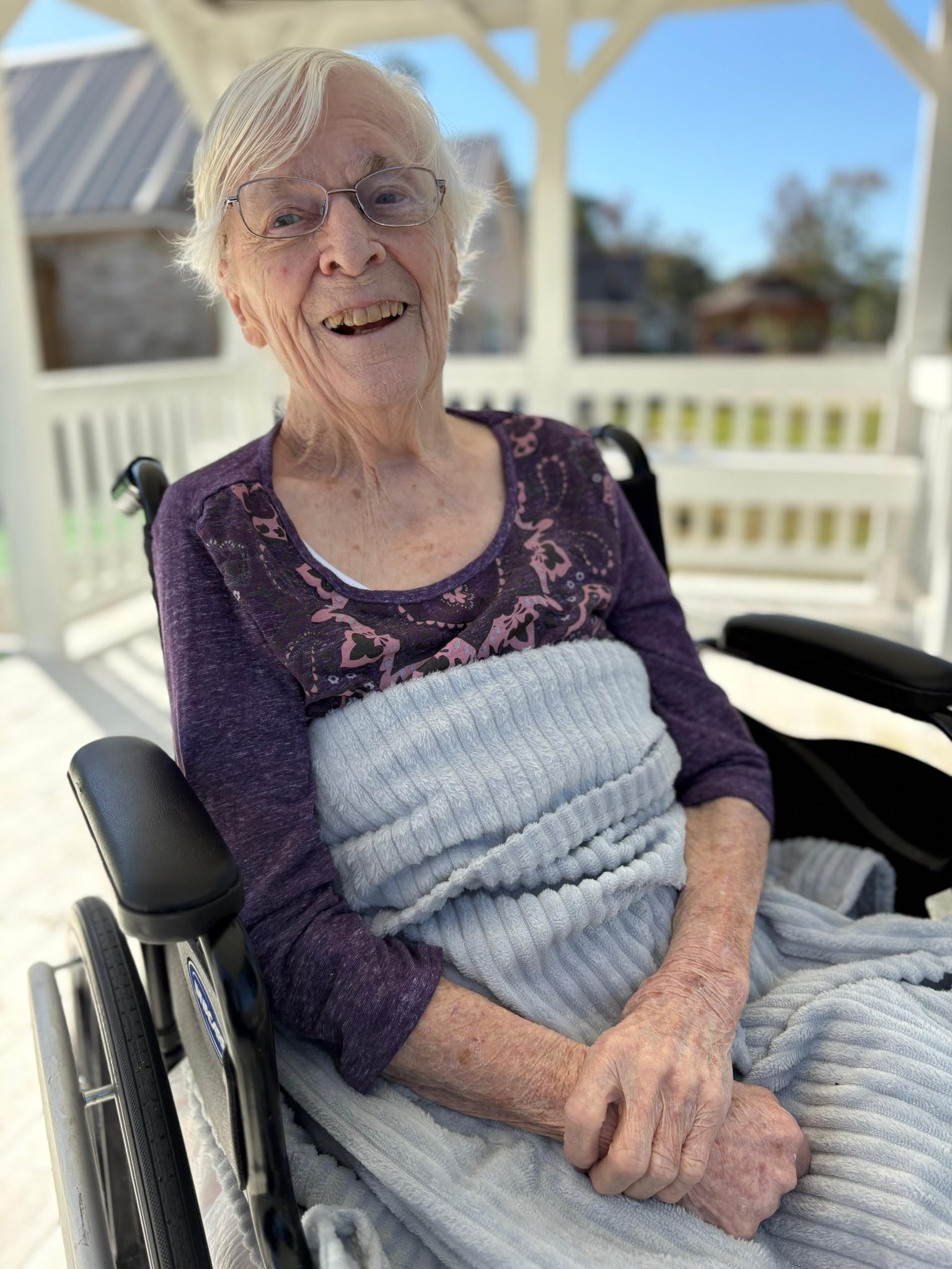 A smiling resident enjoying time outdoors at Total Loving Care